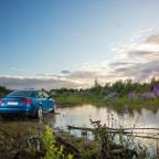red chevrolet camaro on lake